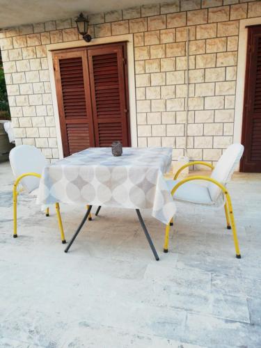 a table and two chairs sitting in front of a building at Rooms Radic in Dubrovnik
