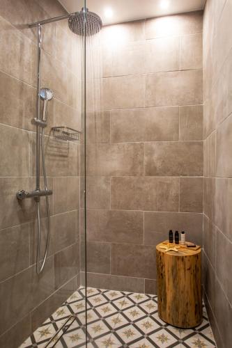 a shower stall with a wooden stump in a bathroom at The Frogs_Guest House in Athens