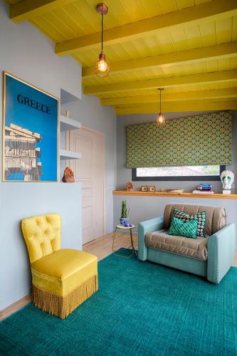 a living room with a couch and a chair at The Frogs_Guest House in Athens
