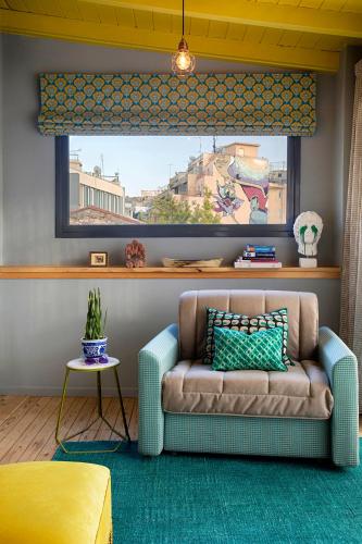 a living room with a couch and a window at The Frogs_Guest House in Athens