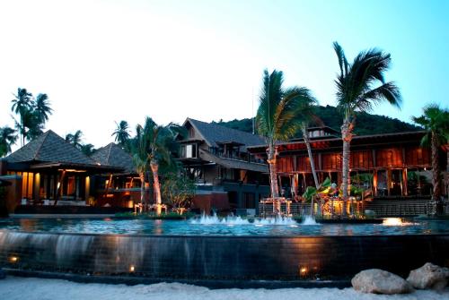 a resort with a fountain in front of a building at Mai Samui Beach Resort & Spa - SHA Plus in Ban Bang Po