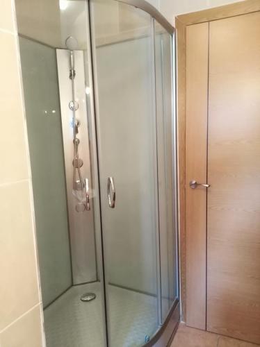 a shower with a glass door in a bathroom at CR TESOL 6 SON - ALT ANEU in Son