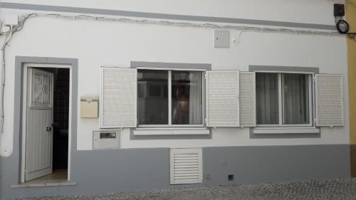 a white building with windows and a door at Casa Algarvia in Lagos