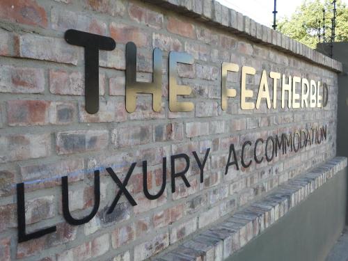 a brick wall with the sign for the fertilizer utility association at The Featherbed - Oudtshoorn in Oudtshoorn