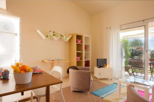 a living room with a table and a dining room at Residence Agula Mora in Lecci