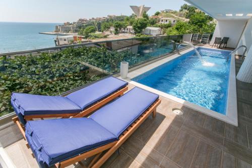 a balcony with a swimming pool and the ocean at Villa Delux in Ulcinj
