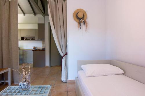 a small bedroom with a bed and a kitchen at Kripia Holiday Villas in Kardamili