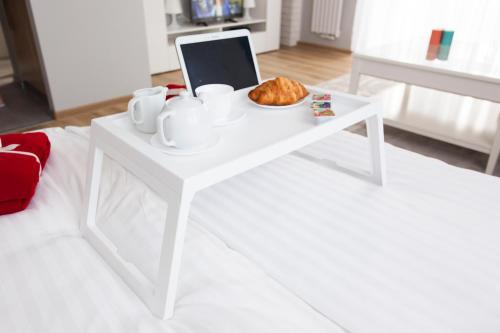a white coffee table with a plate of food on it at Studio Morski Klimat in Władysławowo