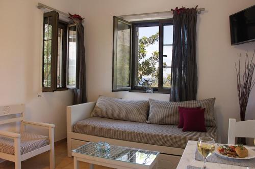 a living room with a couch and a table at Kripia Holiday Villas in Kardamili
