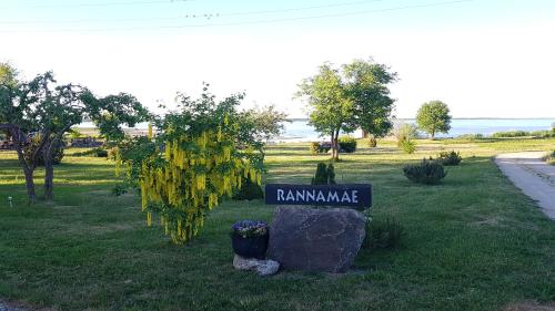 a sign that says ramamineamine on a rock in a park at Rannamäe Apartments in Suure-Rootsi