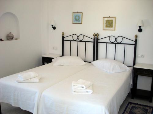 a bedroom with two white towels on a bed at Panorama Hotel in Naxos Chora