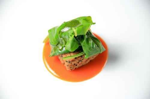 a piece of food on a plate with lettuce at Locanda Belvedere in Saludecio