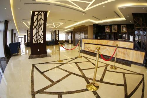 a lobby with a large lobby with a red ribbon at SAS Al Olaya Hotel Suites in Al Khobar