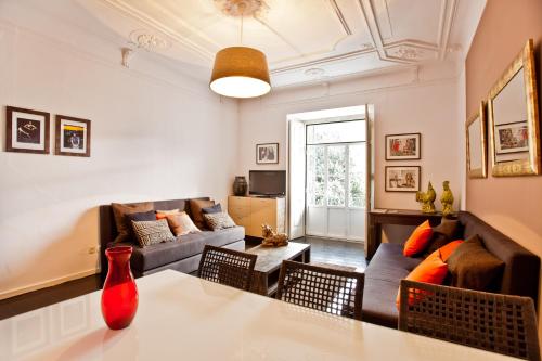 a living room with a couch and a table at Apartments of the Marques in Lisbon