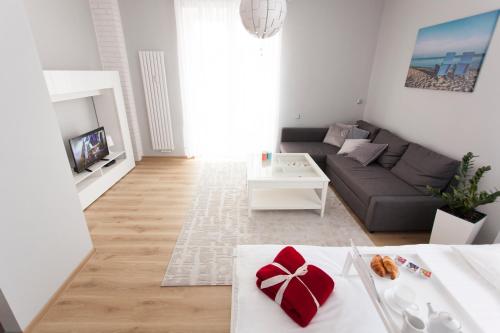 a living room with a couch and a table at Studio Morski Klimat in Władysławowo