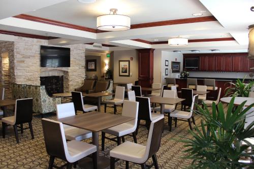 a restaurant with tables and chairs and a fireplace at Wingate by Wyndham Columbia/Lexington in Lexington