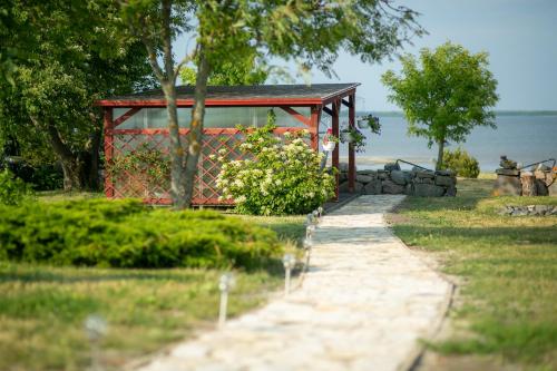 a pathway leading to a gazebo near the water at Rannamäe Apartments in Suure-Rootsi