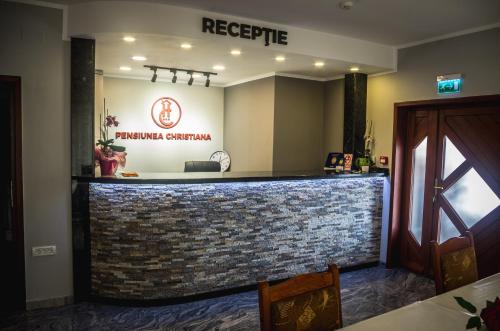 a bar in a restaurant with a brick wall at Pensiunea Christiana in Arad