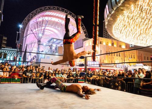 a dog laying on the ground in front of a crowd at Plaza Hotel & Casino in Las Vegas