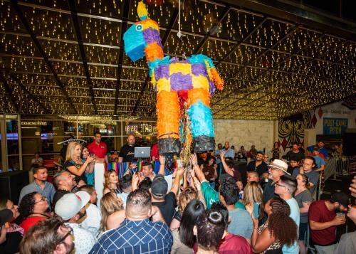 a crowd of people standing in front of a performer at Plaza Hotel & Casino in Las Vegas