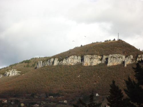 a mountain with a cross on top of it at Hotel des Voyageurs in Millau