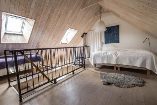 a bedroom with a bed and a staircase in a attic at Apan & Klyset in Simrishamn