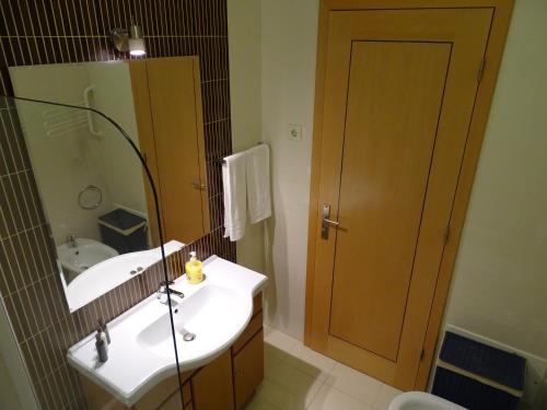 a bathroom with a sink and a mirror at Casa Afonso Henriques in Burgau