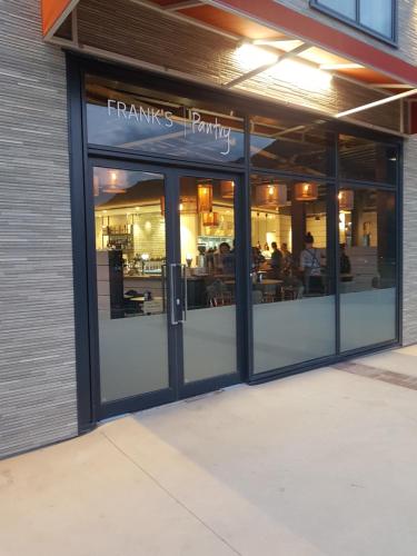 a restaurant with its doors open with people inside at Wyndham Garden Remarkables Park Queenstown in Queenstown