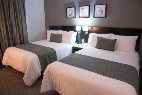 a hotel room with two beds in a room at LaiLa Hotel CDMX Reforma in Mexico City