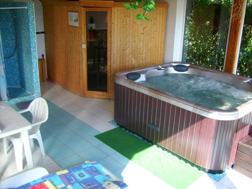 a large hot tub on a porch of a house at Agria Wellness Guesthouse in Eger