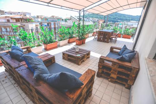 a room with a couch and tables and a balcony at Il Viaggiatore Serapo in Gaeta