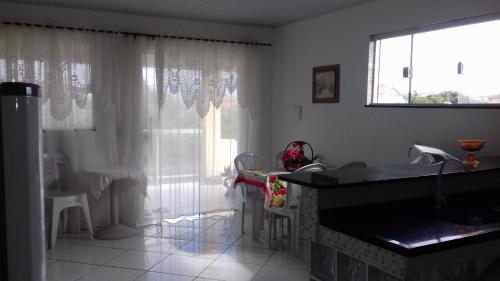 a bathroom with a sink and a large window at Saquarema Surf in Saquarema