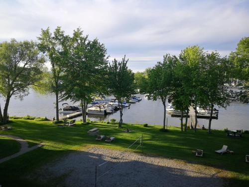a view of a marina with boats in the water at Condo de L'Oberge in Magog-Orford