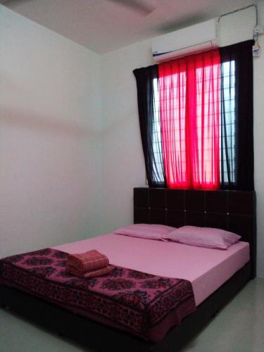 a bedroom with a bed with a window with red lights at Kak Chik Homestay Kepala Batas in Kepala Batas