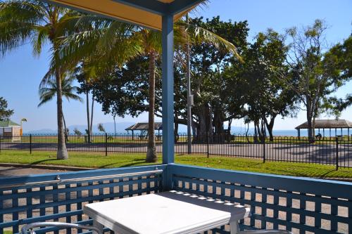 a table and chairs sitting on a bench near the beach at BIG4 Tasman Holiday Parks - Rowes Bay in Townsville