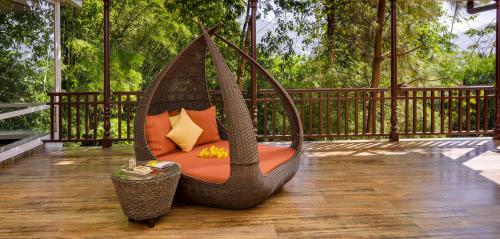 a hammock chair sitting on a deck at Mayfair Spa Resort & Casino in Gangtok