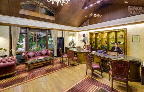 a living room with leather furniture and a bar at Mayfair Spa Resort & Casino in Gangtok