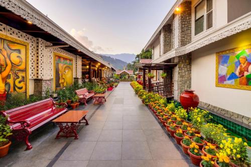 a corridor of a building with benches and potted plants at Mayfair Spa Resort & Casino in Gangtok