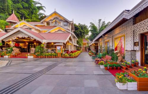 a street with flowers in pots in front of buildings at Mayfair Spa Resort & Casino in Gangtok