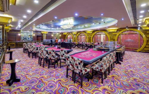 a restaurant with tables and chairs in a room at Mayfair Spa Resort & Casino in Gangtok