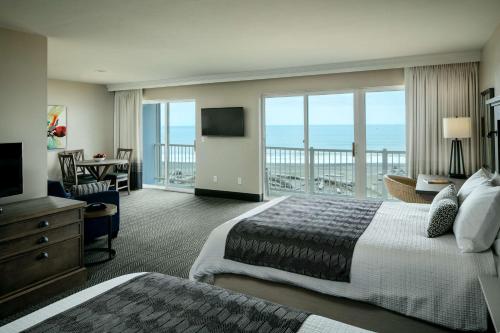 a hotel room with two beds and a view of the ocean at Beachfront Inn in Brookings