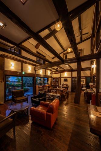 a living room with couches and tables in a building at SOY in Takayama