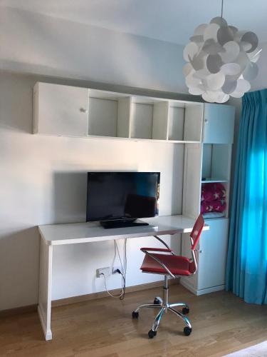 a desk with a computer and a chair in a room at Amazing Apartament in Buenos Aires