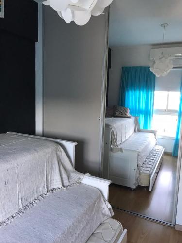 a bedroom with two beds and a mirror at Amazing Apartament in Buenos Aires
