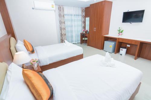 a hotel room with two beds and a television at Samrong Garden in Udon Thani