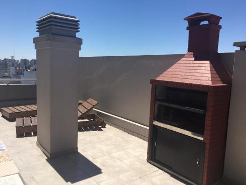 a brick fireplace on the roof of a building at Amazing Apartament in Buenos Aires