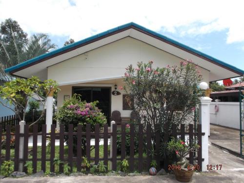a house with a fence in front of it at Ryans Resort in Prasat