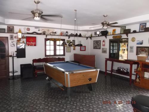 a room with a pool table in the middle of it at Ryans Resort in Prasat
