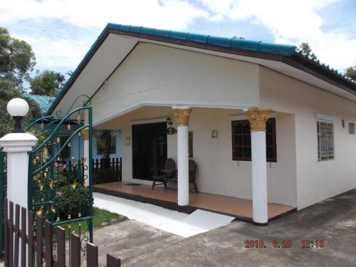 a small house with a porch at Ryans Resort in Prasat