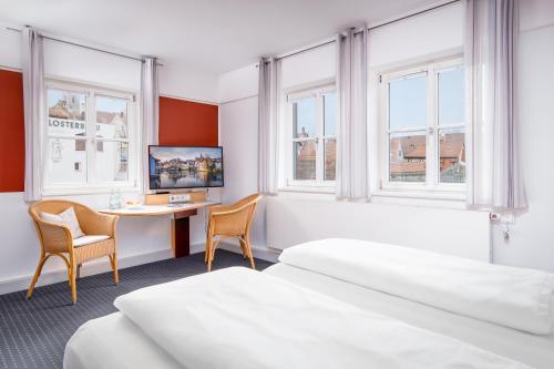 Postel nebo postele na pokoji v ubytování Hotel Nepomuk